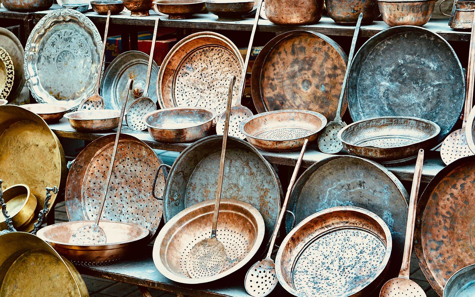 The interior of a copper pan in close detail — copper body against its pale tin or stainless lining